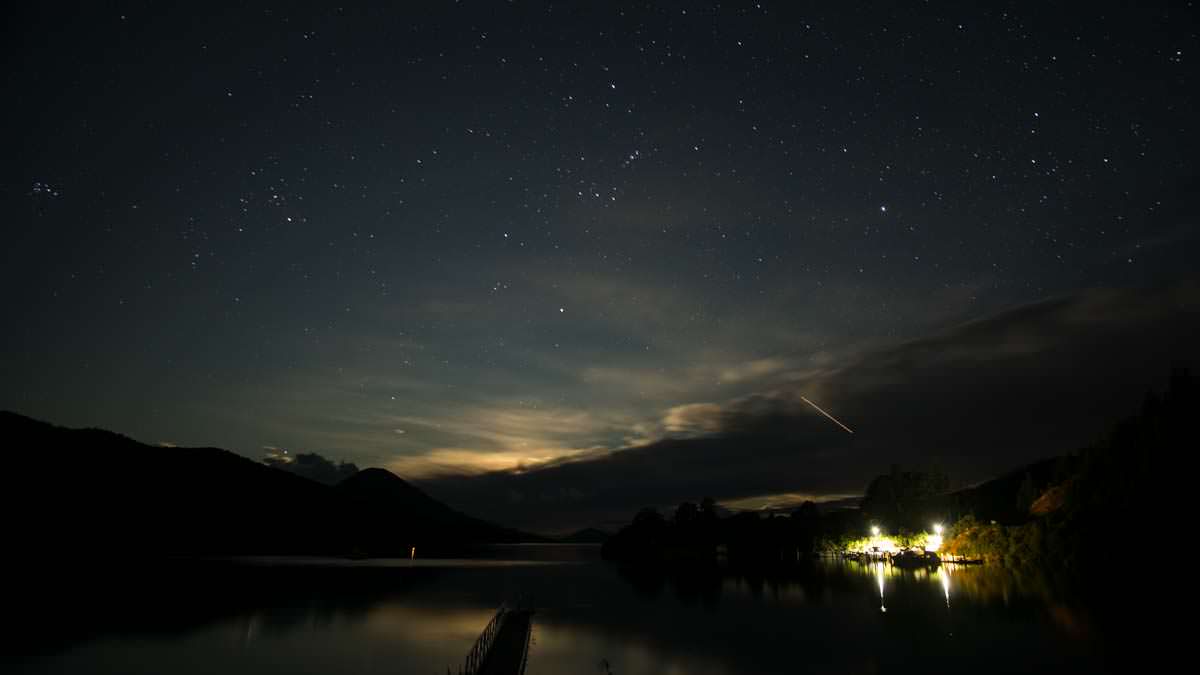 Nachthimmel mit Sternschnuppe über der Elaine Bay, Neuseeland